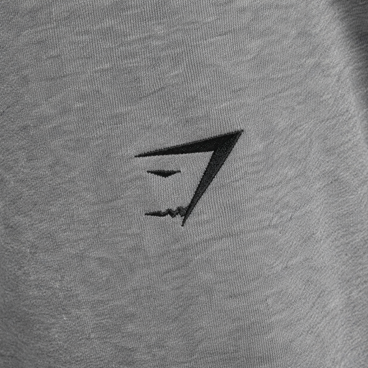 Gymshark Essential Oversized Joggers Charcoal Grey Marl, detalle de logo y material — Crazy!Duck Hype
