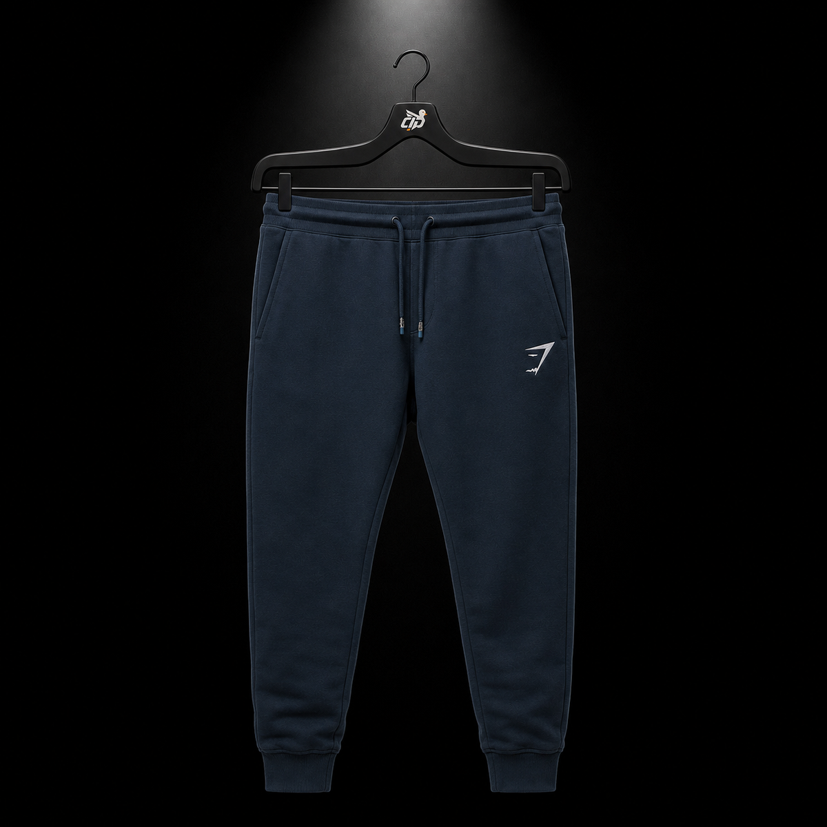 Gymshark Crest Joggers Navy, vista frontal — Crazy!Duck Hype