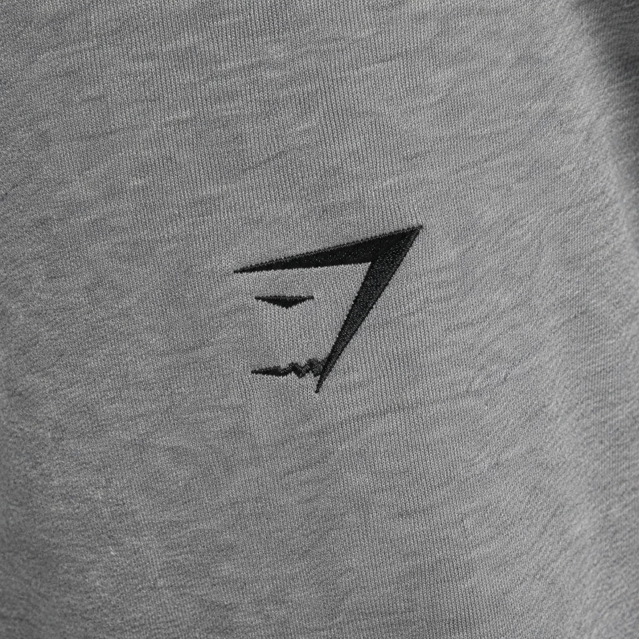 Gymshark Essential Oversized Joggers Charcoal Grey Marl, detalle de logo y material — Crazy!Duck Hype