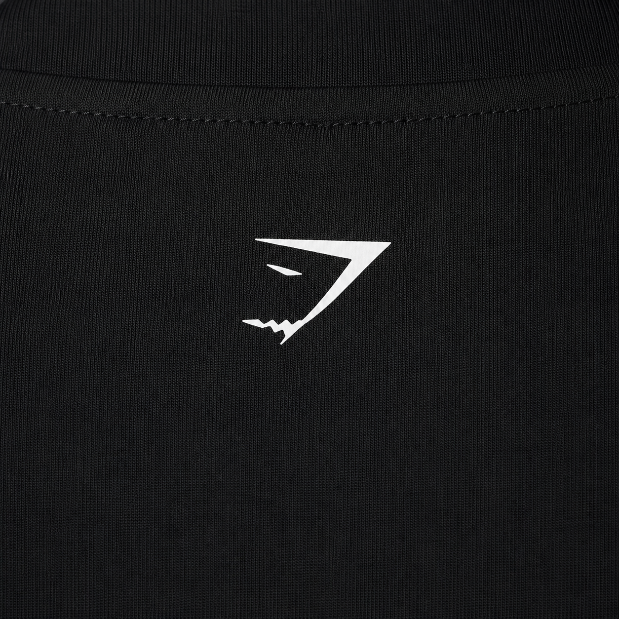 Gymshark Everyday Seamless Zip Tracktop Black, detalle de logo y material — Crazy!Duck Hype