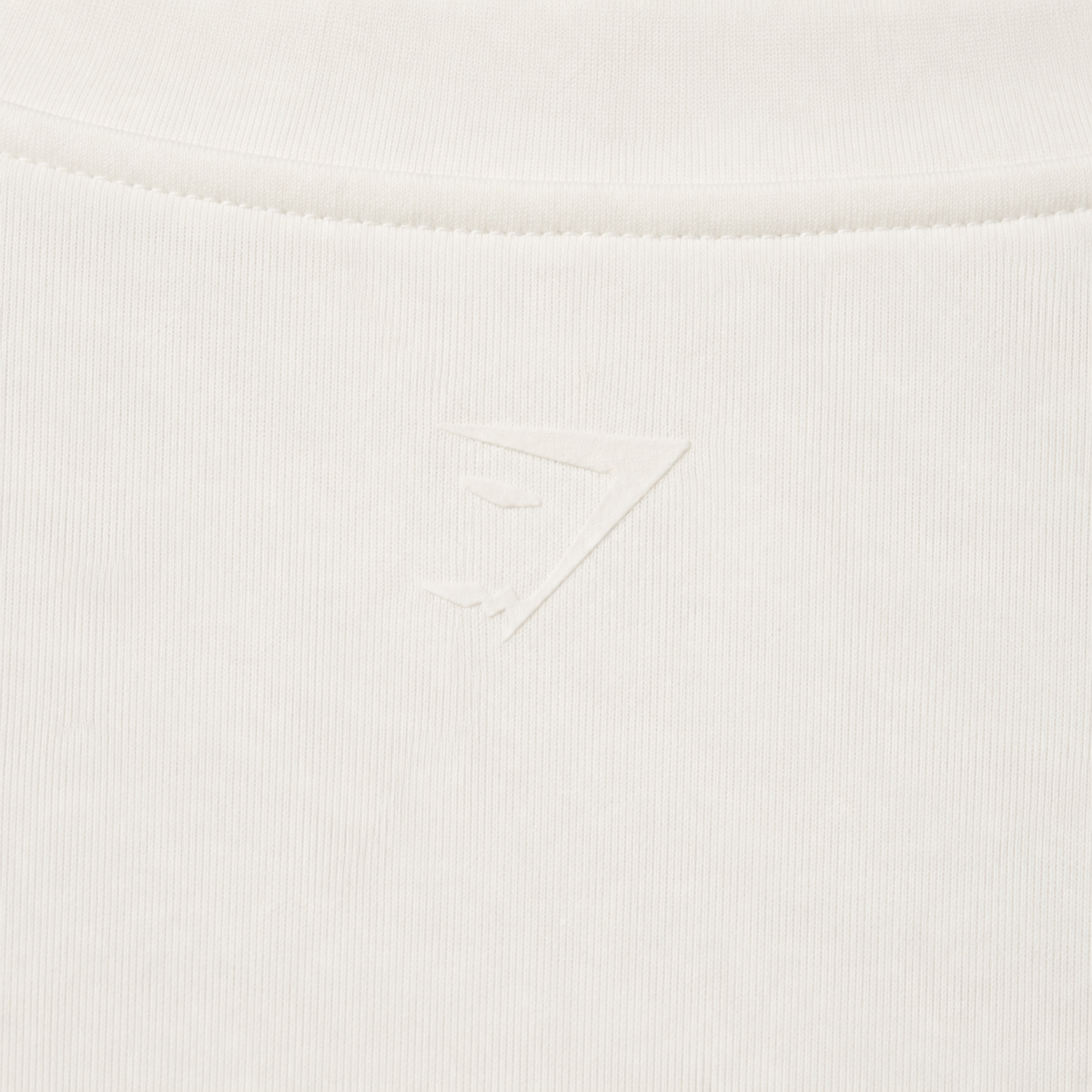 Gymshark Everyday Seamless Zip Tracktop Soft White, detalle de logo y material — Crazy!Duck Hype