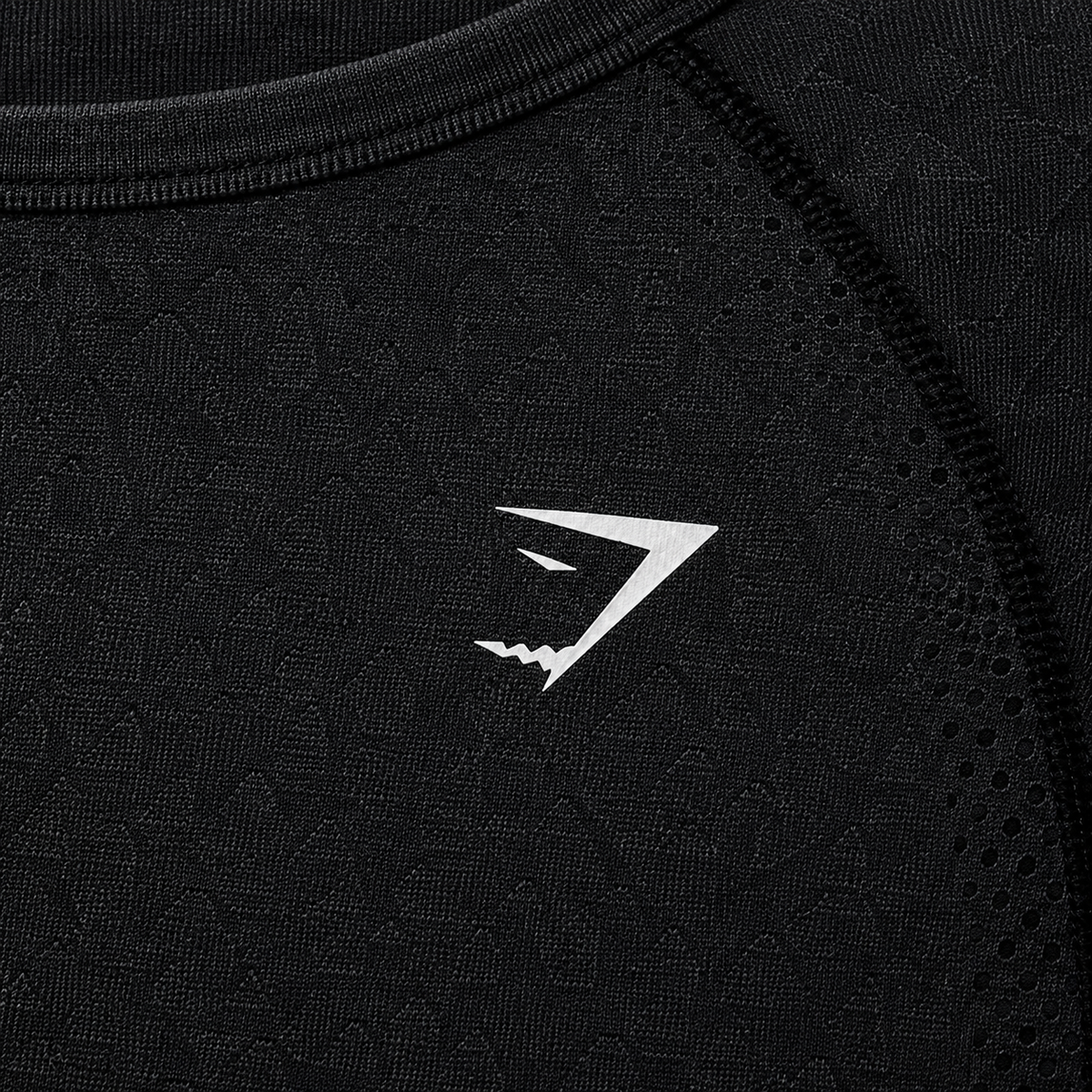 Gymshark Vital Seamless 2.0 Crop Top Black Marl, detalle de logo y material — Crazy!Duck Hype